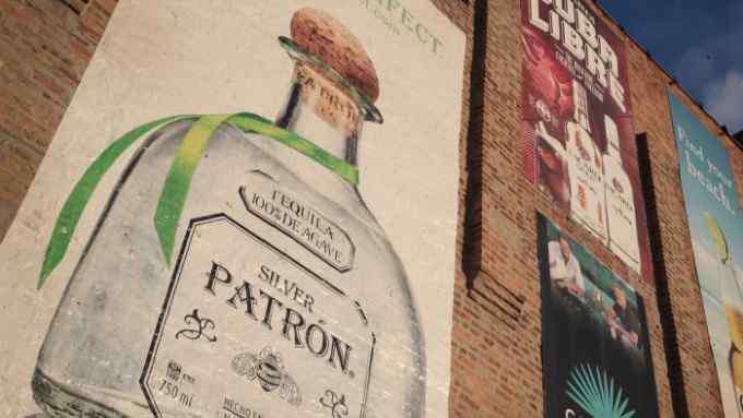 CHICAGO, IL - JANUARY 22:  Banners advertising Patron Tequila, Bacardi Rum and other products are shown outside of a liquor store on January 22, 2018 in Chicago, Illinois. Bacardi Ltd., which currently has a 30 percent interest in Patrón, has made a deal to purchase a controlling interest in the premium tequila maker.  (Photo by Scott Olson/Getty Images)