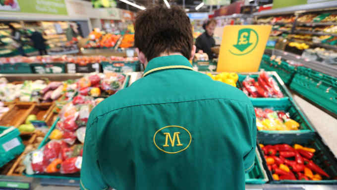 An employee works on the fresh vegetable display at a Morrisons supermarket, operated by William Morrisons Supermarkets Plc, in Crawley, U.K., on Tuesday, March 3, 2015. Wm Morrison Supermarkets Plc named David Potts as chief executive officer, tasking the former head of Tesco Plc's Asia unit with reviving the ailing British grocer. Photographer: Chris Ratcliffe/Bloomberg
