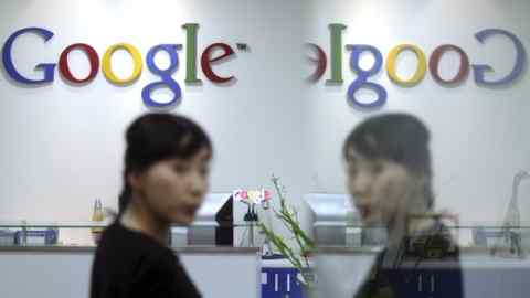 An employee of Google Korea is reflected on the glass door as she walks at its office in Seoul, South Korea, Tuesday, May 3, 2011. South Korean police say they've raided the offices of Google Korea and Daum Communications Corp. for allegedly collecting private information without permission. (AP Photo/ Choi Jae-gu, Yonhap)  KOREA OUT