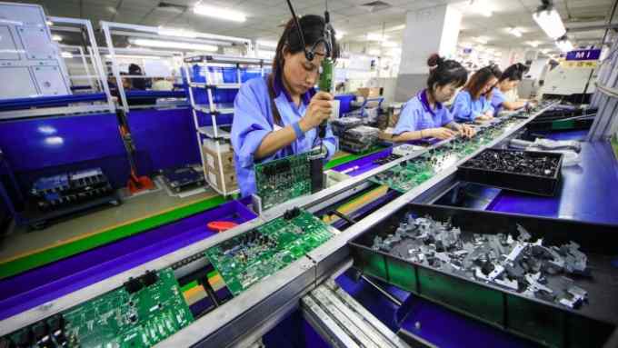Women work at the production line manufacturing electronic keyboards at a factory of the Tianjin Yamaha Electronic Musical Instruments Co. in Tianjin, China December 4, 2018. Picture taken December 4, 2018. REUTERS/Stringer ATTENTION EDITORS - THIS IMAGE WAS PROVIDED BY A THIRD PARTY. CHINA OUT.
