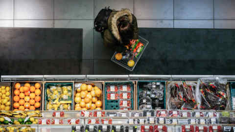 FILE: A shopper browses fresh fruit and vegetables in the foodhall inside a branch of Marks & Spencer Group Plc (M&S) in London, U.K., on Tuesday, Dec. 5, 2017. A decline in sales of food and clothing in the fourth quarter underlined the need for a restructuring of the 134-year-old retailer, including plans to shut nearly one-third of its large stores in the U.K. Our editors select the best archive images of M&S as profits drop 62% and store closures planned. Photographer: Luke MacGregor/Bloomberg