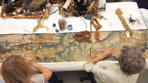 Work on a large tapestry at the National Trust Textiles Conservation Studio