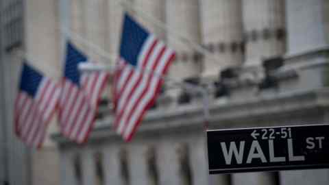 (FILES) In this file photo taken on February 16, 2017 a street sign is seen near the New York Stock Exchange in New York. - Bolstered by a period of extraordinary monetary stimulus followed by generous tax cuts, Wall Street stands at the cusp of another landmark this week. The US stock market on August 22, 2018 will mark 3,453 straight days without suffering a drop of 20 percent. That makes it the longest &quot;bull market&quot; since World War II, according to leading Wall Street statisticians. (Photo by Bryan R. Smith / AFP)BRYAN R. SMITH/AFP/Getty Images