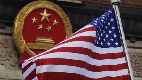 FILE - In this Nov. 9, 2017 file photo, an American flag is flown next to the Chinese national emblem during a welcome ceremony for visiting U.S. President Donald Trump outside the Great Hall of the People in Beijing. China warned Washington on Thursday, Jan. 10, 2018, it will &quot;resolutely safeguard&quot; its interests ahead of a possible decision in an investigation into whether Beijing improperly pressures foreign companies to hand over technology. (AP Photo/Andy Wong, File)