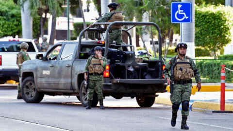 Soldiers patrol the surroundings of the government palace in Culiacan, Sinaloa state, Mexico, on October 18, 2019. - Mexico's president faced a firestorm of criticism Friday as his security forces confirmed they arrested kingpin Joaquin &quot;El Chapo&quot; Guzman's son, then released him when his cartel responded with an all-out gun battle. (Photo by ALFREDO ESTRELLA / AFP) (Photo by ALFREDO ESTRELLA/AFP via Getty Images)