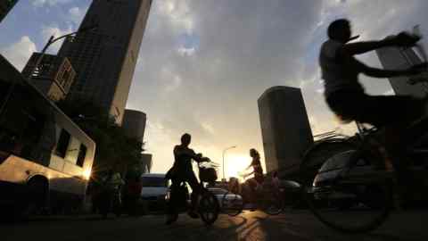 epa05420046 A picture made available on 11 July 2016 shows cyclists silhouetted during sunset in the Central Business Distrct of Beijing, China, 01 July 2016. China has a current population of 1.38 billion as of 06 July 2016 according to the latest United Nations estimates. This is equivalent to 18.72 percent of the total world population, making it the most populous country in the world. The most populous country of the world has a peculiar demographic situation as a result of more than three decades of the 'one child policy'. With 40 million more of men than women (and around 18 million more of boys under 15 than girls of the same age, according to official data), it is forecasted that by 2020 there will be at least 30 million of young men unable to find a spouse in the country. World Population Day falls on 11 July.  EPA/HOW HWEE YOUNG
