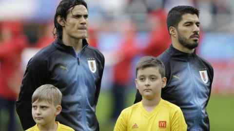 Uruguay's Edinson Cavani, left, stands with his teammate Uruguay's Luis Suarez prior to the start of the group A match between Egypt and Uruguay at the 2018 soccer World Cup in the Yekaterinburg Arena in Yekaterinburg, Russia, Friday, June 15, 2018. (AP Photo/Natacha Pisarenko)