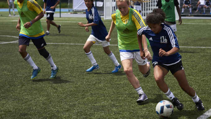 This photo taken on July 5, 2016 in Lyon shows budding football players playing during the &quot;Streetfootballworld Festival 16&quot;, an international solidarity tournament that takes place for the first time during the duration of the UEFA Euro 2016 football championship. 
Some 450 girls and boys between 14 and 18 coming from 60 countries, the Brazilian favelas of Rio, shanty towns in India, South African townships and underprivileged European suburbs, meet thanks to &quot;Streetfootballworld Festival 16&quot; aiming at changing the world through football. / AFP / JEAN-PHILIPPE KSIAZEK        (Photo credit should read JEAN-PHILIPPE KSIAZEK/AFP/Getty Images)