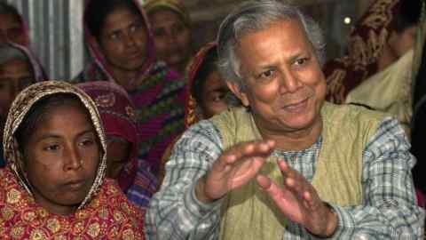 YUNUS AND VILLAGERS...** FILE ** In a file photo Professor Mohammad Yunus, founder of Grameen Bank, a micro credit institution, explains to villagers the benefits of the system at Kalampur village in Dhaka, Bangladesh, Jan. 21, 2004. Yunus and the Grameen Bank were awarded the N0bel Peace Prize Friday Oct. 13, 2006, in Oslo, Norway. (AP Photo/Pavel Rahman)