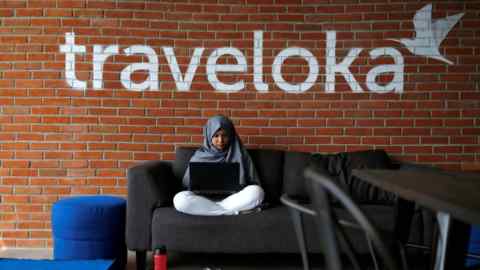 FILE PHOTO: An employee of Traveloka works at the company's headquarters in Jakarta, Indonesia, August 2, 2017. REUTERS/Beawiharta/File Photo