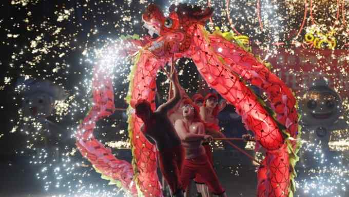 TOPSHOT - Dragon dancers perform at a park in Beijing on the fourth day of the Lunar New Year on February 8, 2019. - China is marking the arrival of the Year of the Pig with a week-long Spring Festival holiday, the most important festival of the year. (Photo by GREG BAKER / AFP) (Photo credit should read GREG BAKER/AFP/Getty Images)
