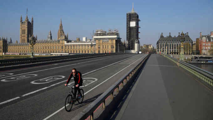 A cyclist rides over Westminster Bridge as the spread of the coronavirus disease (COVID-19) continues, London, Britain, April 10, 2020. REUTERS/Toby Melville