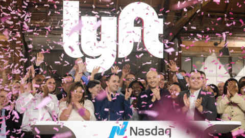 Lyft co-founders John Zimmer, front third from left, and Logan Green, front third from right, cheer as they as they ring a ceremonial opening bell in Los Angeles, Friday, March 29, 2019. On Friday the San Francisco company's stock will begin trading on the Nasdaq exchange under the ticker symbol &quot;LYFT.&quot; (AP Photo/Ringo H.W. Chiu)