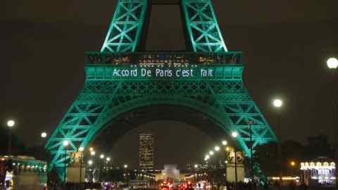 The Eiffel Tower (Tour Eiffel) is illuminated with the lettering reading 'The Paris accord is done' in Paris on November 4, 2016, to celebrate the first day of the application of the Paris COP21 climate accord.
The worldwide pact to battle global warming entered into force on November 4, just a week before nations reassemble to discuss how to make good on their promises to cut planet-warming greenhouse gases. Dubbed the Paris Agreement, it is the first-ever deal binding all the world's nations, rich and poor, to a commitment to cap global warming caused mainly by the burning of coal, oil and gas.
 / AFP / PATRICK KOVARIK        (Photo credit should read PATRICK KOVARIK/AFP/Getty Images)