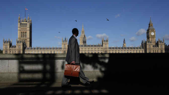 A man walks past the Houses of Parliament in London May 10, 2011. The Palace of Westminster, inside the Houses of Parliament, could host wedding receptions under plans to cut Parliament's subsidised catering bill, local media report. REUTERS/Suzanne Plunkett