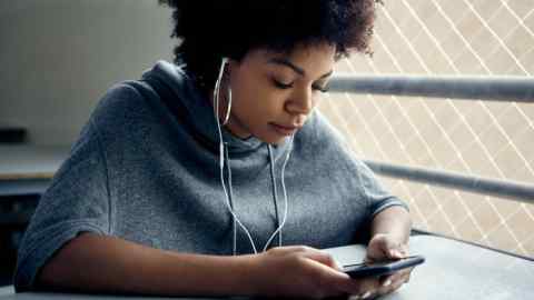 Mandatory Credit: Photo by PhotoAlto/REX/Shutterstock (9714819a) MODEL RELEASED Young woman looking at smartphone and listening to earphones VARIOUS