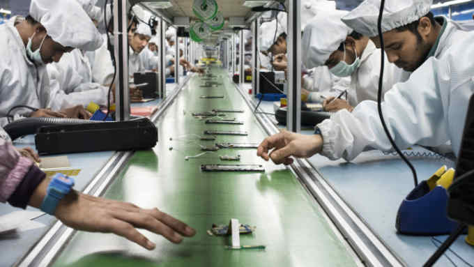 INTEX TECHNOLOGIES FACTORY, NOIDA, UTTAR PRADESH, INDIA - 2016/02/10: Workers assemble smartphones on the production line inside the Intex Technologies brand plant in Noida. Intex Technologies is a Smartphone manufacturer in India and it employs over 3000 technicians for its mobile phone assemble operations in 2017. (Photo by Miguel Candela/SOPA Images/LightRocket via Getty Images)