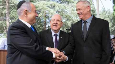 Mandatory Credit: Photo by ABIR SULTAN/EPA-EFE/Shutterstock (10619084a) (FILE) - Israeli Prime Minister Benjamin Netanyahu (L), Israeli President Reuven Rivlin (C) and Benny Gantz, former Israeli Army Chief of Staff and chairman of the Blue and White Israeli centrist political alliance (R) join hands as they attend a memorial service for late Israeli president Shimon Peres at Mount Herzl in Jerusalem, 19 September 2019(issued 04 April 2020). Media report that Netanyahu and Gantz agreed to sign a coalition deal to form a government after three elections and to rotate the premiership. Netanyahu and Gantz agree on Israeli government, Jerusalem, Israel - 19 Sep 2019