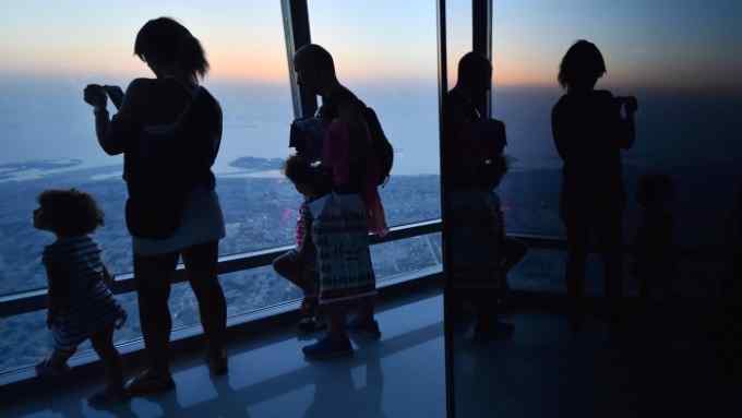 People visit the 148 floor of the Burj Khalifa, the tallest building in the world standing at 828 metres, on May 16, 2017. / AFP PHOTO / GIUSEPPE CACACE (Photo credit should read GIUSEPPE CACACE/AFP/Getty Images)