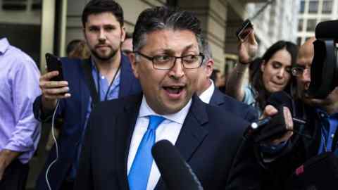 Makan Delrahim, U.S. assistant attorney general for the antitrust division, center, speaks to members of the media outside of federal court in Washington, D.C., U.S., on Tuesday, June 12, 2018. AT&T Inc. was cleared by a judge to take over Time Warner Inc. in an $85 billion deal that the mobile-phone giant says will fuel its evolution into a media powerhouse that can go head-to-head with Netflix Inc. and Amazon.com Inc. Photographer: Al Drago/Bloomberg