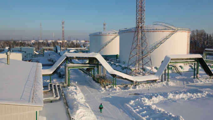 Oil storage tanks stand at the custody transfer facility in the Salym Petroleum Development oil fields near Salym, Russia, on Wednesday, Feb. 5, 2014. Salym Petroleum Development, the venture between Shell and Gazprom Neft, has started drilling the first of five horizontal wells over the next two years that will employ multi-fracturing technology, according to a statement today. Photographer: Andrey Rudakov/Bloomberg