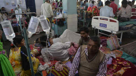 Indian patients undertaking treatment for viral infections including dengue fever lay on the floor in the overcrowded Siliguri District Hospital in Siliguri on November 2, 2017.