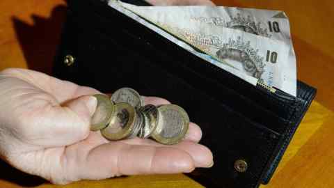 File photo dated 06/02/17 of a woman holding coins and a purse containing notes. Inflation is expected to remain at its highest level in nearly four years, as rising prices on the back of the Brexit-hit pound continued to squeeze British households. PRESS ASSOCIATION Photo. Issue date: Sunday July 16, 2017. The Consumer Price Index (CPI) measure of inflation is forecast to come in at 2.9% in June, according to consensus estimates, in line with May's figure but above April's reading of 2.7%. See PA story ECONOMY Inflation. Photo credit should read: John Stillwell/PA Wire