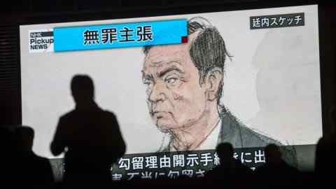 TOPSHOT - Pedestrians pass by a television screen showing a news program displaying a sketch of former Nissan chief Carlos Ghosn in the courtroom, in Tokyo on January 8, 2019, as the headline reads in Japanese &quot;Innocence claim.&quot; - Former Nissan boss Carlos Ghosn said on January 8 he had been &quot;wrongly accused and unfairly detained&quot; at a high-profile court hearing in Japan, his first appearance since his arrest in November rocked the business world. (Photo by Behrouz MEHRI / AFP)BEHROUZ MEHRI/AFP/Getty Images