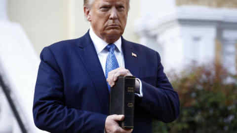 FILE - In this June 1, 2020, file photo, President Donald Trump holds a Bible as he visits outside St. John's Church across Lafayette Park from the White House in Washington. Part of the church was set on fire during protests on Sunday night. (AP Photo/Patrick Semansky, File)