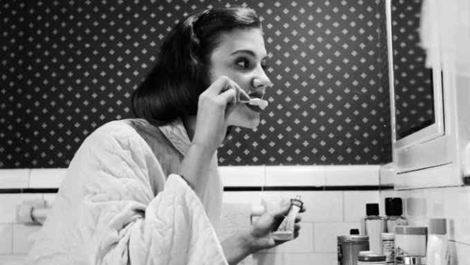 circa 1955: A young woman brushing her teeth in her bathroom. (Photo by Three Lions/Getty Images)