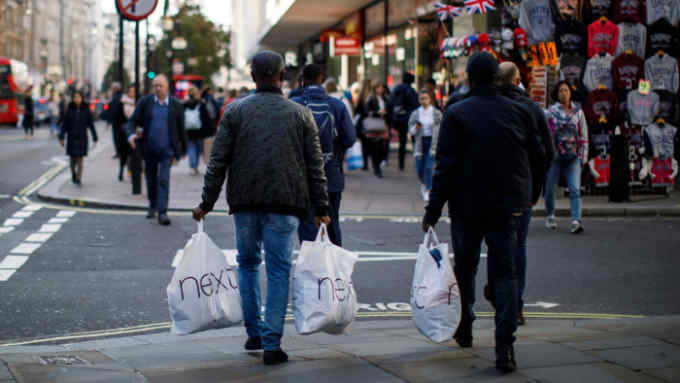 Shoppers walk past Debenhams store in Oxford Street, London on October 25, 2018.