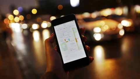epa04944340 A picture made available on 23 September 2015 shows a view of Didi Kuaidi's smartphone app for customers shown on a mobile phone along a road in Beijing, China, 22 September 2015. With almost 20 million cars sold last year, China is the largest passenger cars market in the world and chronic traffic congestions in many of its cities like Beijing is one of the reasons why taxi and car hailing smartphone apps offered by Didi Kuaidi and Uber Technologies Inc. are widely popular with commuters. EPA/HOW HWEE YOUNG