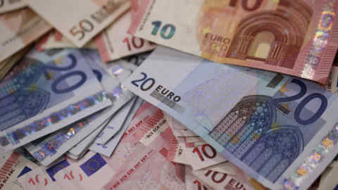 Multiple denomination euro banknotes are arranged for a photograph inside a Travelex store, operated by Travelex Holdings Ltd., in London, U.K., on Monday, Jan. 12, 2015. The euro approached a nine-year low against the dollar as European Central Bank officials fueled speculation the institution will start a program of government-bond buying as early as next week to stave off deflation. Photographer: Simon Dawson/Bloomberg