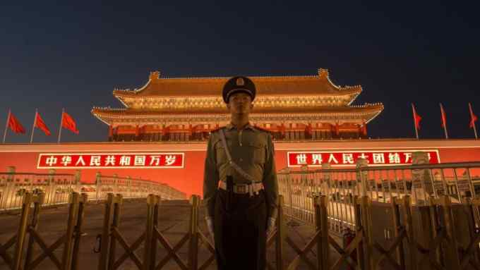 A Chinese paramilitary police officer secures the front gate of the Forbidden City in Beijing on September 28, 2017. China will convene its 19th Party Congress on October 18, state media said, a key meeting held every five years where President Xi Jinping is expected to receive a second term as the ruling Communist Partys top leader. / AFP PHOTO / NICOLAS ASFOURINICOLAS ASFOURI/AFP/Getty Images