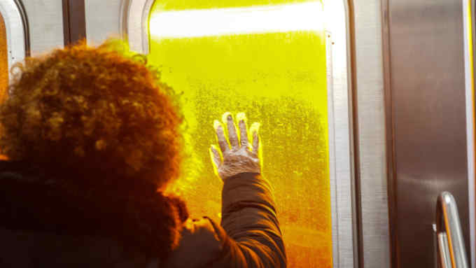 A woman wears a protective glove as she stands at the door of a New York subway train, Tuesday, March 17, 2020. Mayor Bill de Blasio warned New York City residents on Tuesday afternoon to prepare for the possibility of a &quot;shelter in place&quot; order, due to the coronavirus, within the next 48 hours. (Chang W. Lee/The New York Times) / Redux / eyevine Please agree fees before use. SPECIAL RATES MAY APPLY. For further information please contact eyevine tel: +44 (0) 20 8709 8709 e-mail: info@eyevine.com www.eyevine.com