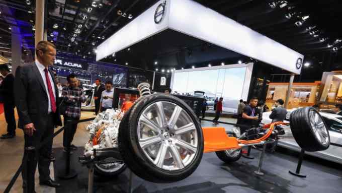Visitors look at an electric powered chassis displayed during the Auto Shanghai 2017 show at the National Exhibition and Convention Center in Shanghai, China, Thursday, April 20, 2017. Volvo Cars, the Chinese-owned Swedish automaker, said Wednesday it plans to make electric cars in China for sale worldwide starting in 2019 amid pressure by Beijing for global auto brands to help develop its fledgling industry in alternatives to gasoline. (AP Photo/Ng Han Guan)
