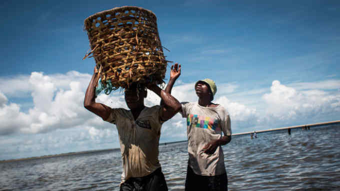 Mozambican fishermen return to the shore after several days of fishing in Palma, where large deposits of natural gas where found offshore, on February 16, 2017. / AFP PHOTO / JOHN WESSELS        (Photo credit should read JOHN WESSELS/AFP/Getty Images)