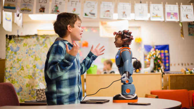 Devin Chaplin, 7, plays a game of &quot;Red Light, Green Light&quot; with Milo, the robot, during some exercises in Julie Jeffcoat's classroom at Kingsbury Elementary.