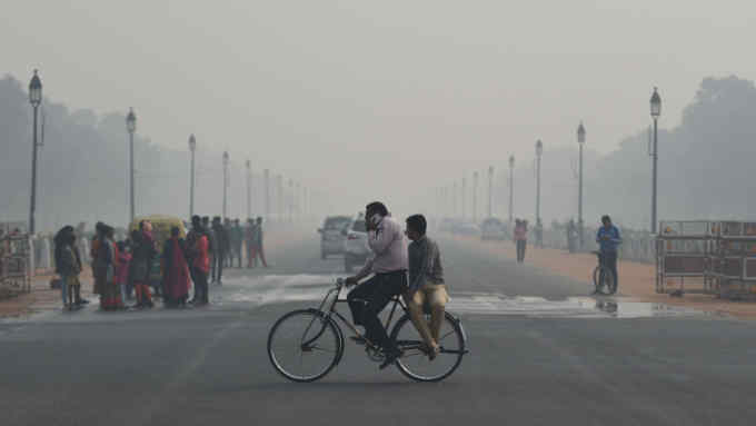 TOPSHOT - A cyclist rides under heavy smog conditions in New Delhi on November 12, 2019. (Photo by Money SHARMA / AFP) (Photo by MONEY SHARMA/AFP via Getty Images)