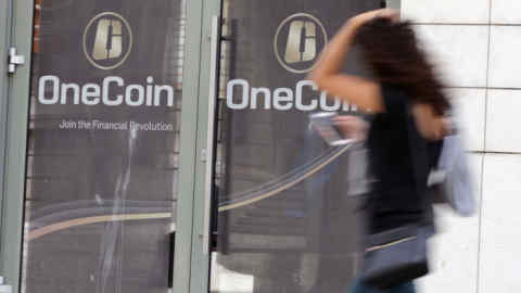 Sofia, Bulgaria - 12 May, 2019: A woman passes by the office of OneCoin cryptocurrency founded by Ruja Ignatova.