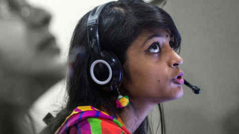 An employee talks through a headset while working at the Avise Techno Solutions LLP call center in Kolkata, India, on Sunday, Dec. 24, 2017. India's political stability and reform push -- including a nationwide consumption tax -- prompted a first upgrade of its sovereign rating in 14 years from Moody's Investors Service in November. Photograph: Taylor Weidman/Bloomberg