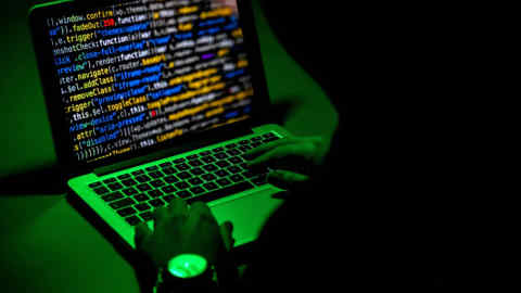 A person types on a laptop. Ecuador's data breach exposed ID numbers, taxpayer IDs, addresses, phone numbers and education and employment records