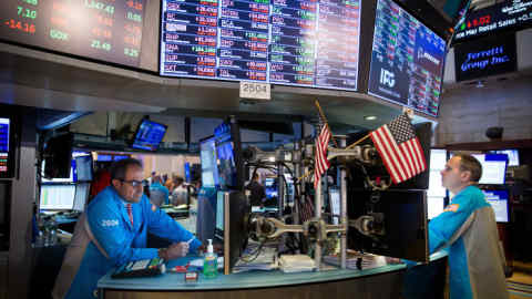 Traders work on the floor of the New York Stock Exchange (NYSE) in New York, U.S., on Friday, June 14, 2019. PetSmart Inc.-controlled Chewy Inc. surged in its first day of trading after raising $1.02 billion in an initial public offering, as investors bet that pet owners will do more of their shopping online for everything from cat food to doggy sweaters. Photographer: Michael Nagle/Bloomberg
