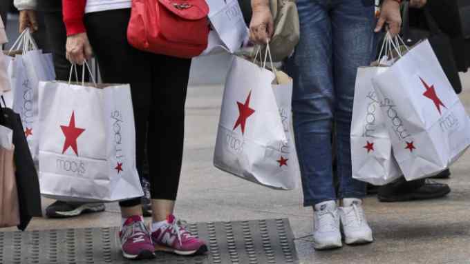 In this Tuesday, May 2, 2017, photo, shoppers holding bags from Macy's wait to cross an intersection in New York. Macy's Inc. reports earnings, Thursday, May 11, 2017. (AP Photo/Bebeto Matthews)