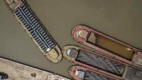 Ships loaded with steel rods and steel wire are moored at a depot in China. Photographer: Qilai Shen/Bloomberg