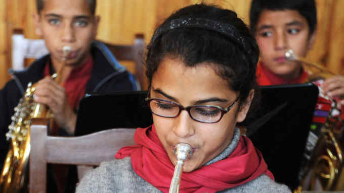 A Young Afghan girl rehearses for a concert in a music class in the Afghan National Institute of Music on October 19, 2011 in Kabul, Afghanistan