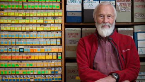 Chris Bonington in front of his picture library at home in Cumbria