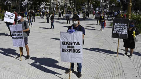 Members of Polo Obrero social organization protest at Plaza de Mayo square holding banners during a May Day demosntration in Buenos Aires, Argentina, on May 1, 2020. - Argentina went to lockdown imposed by the government against the spread of the new coronavirus, COVID-19 since March 20. (Photo by JUAN MABROMATA / AFP) (Photo by JUAN MABROMATA/AFP via Getty Images)