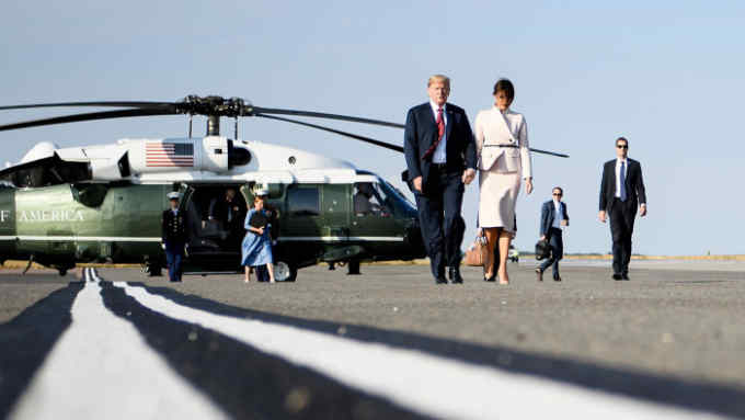 US President Donald Trump and US first lady Melania Trump board Air Force One at London Stansted Airport in Stansted on July 13, 2018, the second day of Trump's UK visit. - Queen Elizabeth II welcomed US President Donald Trump for tea at Windsor Castle on Friday -- a meeting which many Britons find the toughest part of his already contentious trip to swallow. (Photo by Brendan Smialowski / AFP)        (Photo credit should read BRENDAN SMIALOWSKI/AFP/Getty Images)