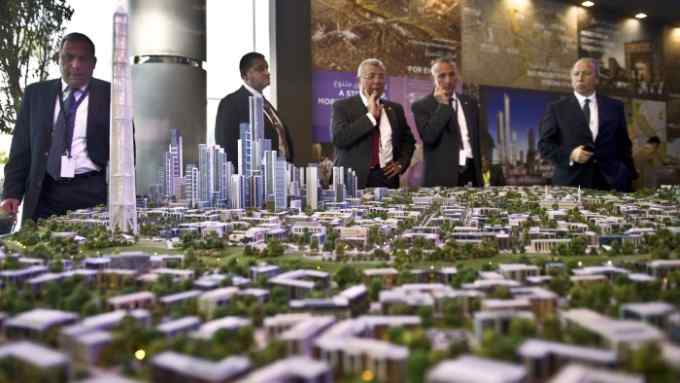 A delegation looks at a scale model of the new Egyptian capital displayed at the congress hall in the Red Sea resort of Sharm el-Sheikh on March 14, 2015. Egypt plans to build a new administrative and business capital east of Cairo that will house five million people and feature a theme park &quot;four times bigger than Disneyland&quot;, a minister announced at a global investor conference. AFP PHOTO / KHALED DESOUKI (Photo credit should read KHALED DESOUKI/AFP/Getty Images)
